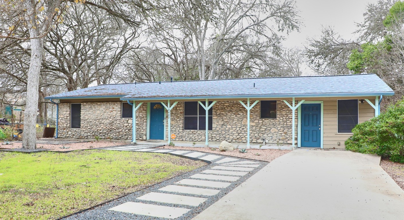 a front view of a house with garden and porch