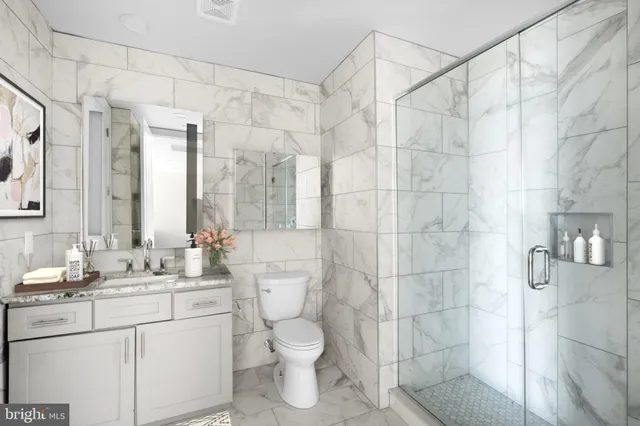 a bathroom with a sink toilet and shower