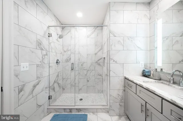 a bathroom with a shower and a sink