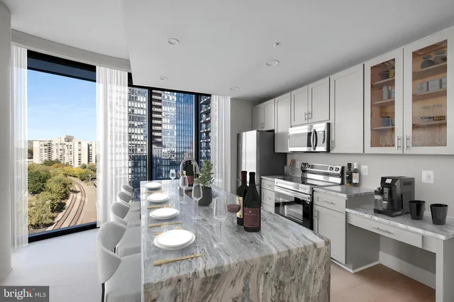 a kitchen with stainless steel appliances wooden floor and furniture