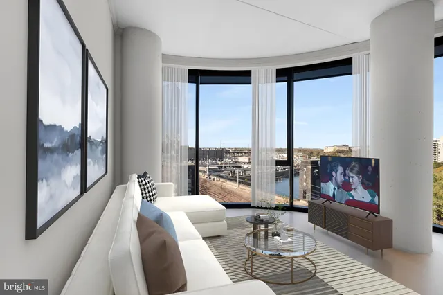 a living room with furniture and large windows