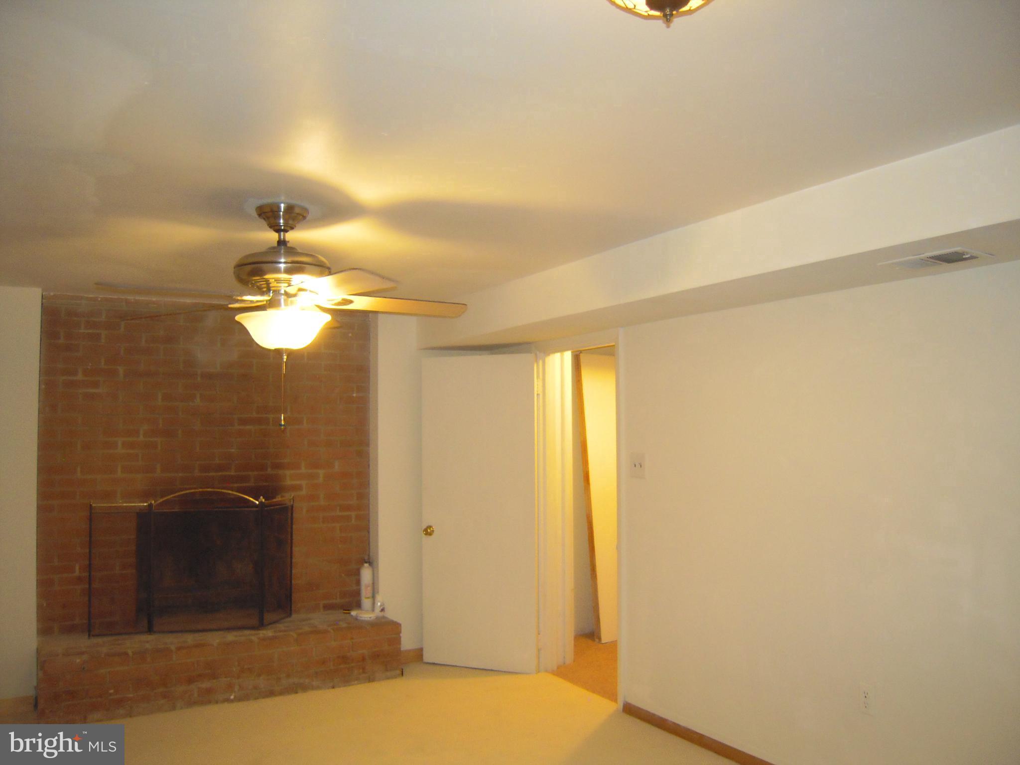 13009 Claxton Drive Laurel, MD 20708 - Photo 22 of 31 Family rm, w/ wd burning fireplace & new carpet!