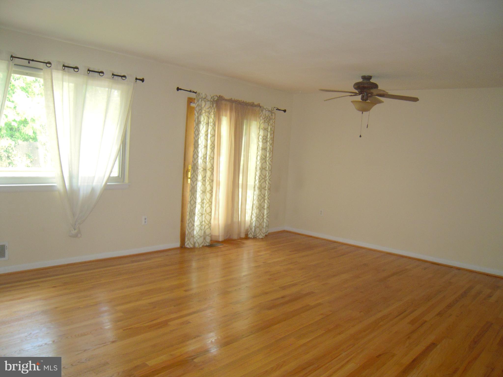 13009 Claxton Drive Laurel, MD 20708 - Photo 8 of 31 Din/Liv Combo w/ Slider to deck, refinished floors