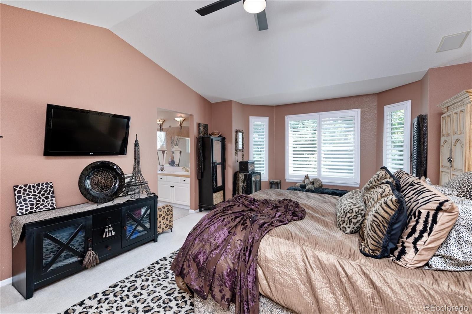 9812 South Spring Hill Place Highlands Ranch, CO 80129 - Photo 16 of 27 a bedroom with a bed and a flat screen tv