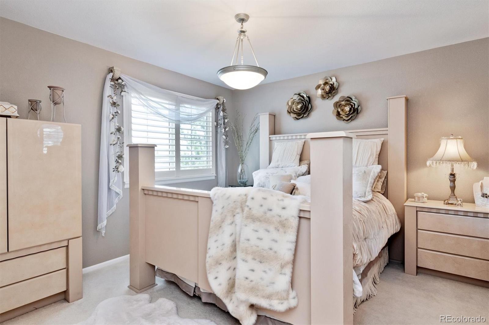 9812 South Spring Hill Place Highlands Ranch, CO 80129 - Photo 19 of 27 a bed room with a bed and a table