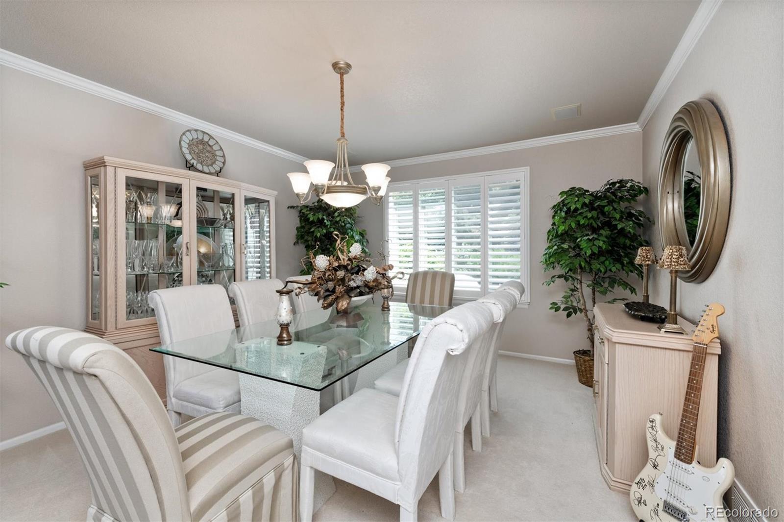 9812 South Spring Hill Place Highlands Ranch, CO 80129 - Photo 6 of 27 a view of a dining room with furniture window and wooden floor