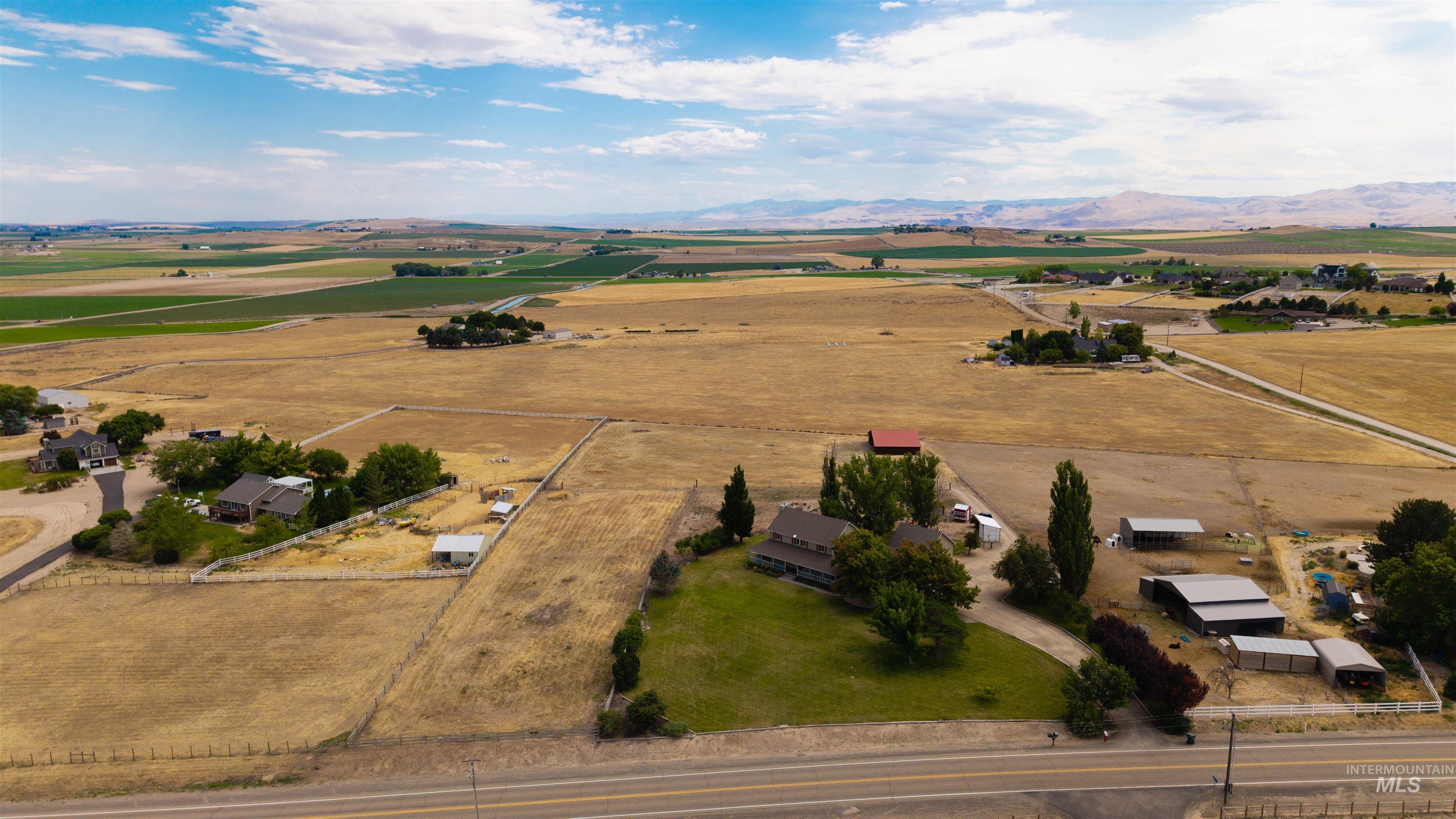 12369 Deer Flat Road Nampa, ID 83686 - Photo 44 of 50 Expansive agricultural property featuring multiple outbuildings, mature trees, and a road frontage