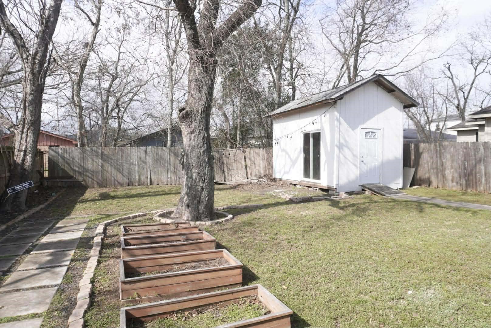 7916 Comal Street Houston, TX 77051 - Photo 2 of 21 a view of a house with pool and trees in the background