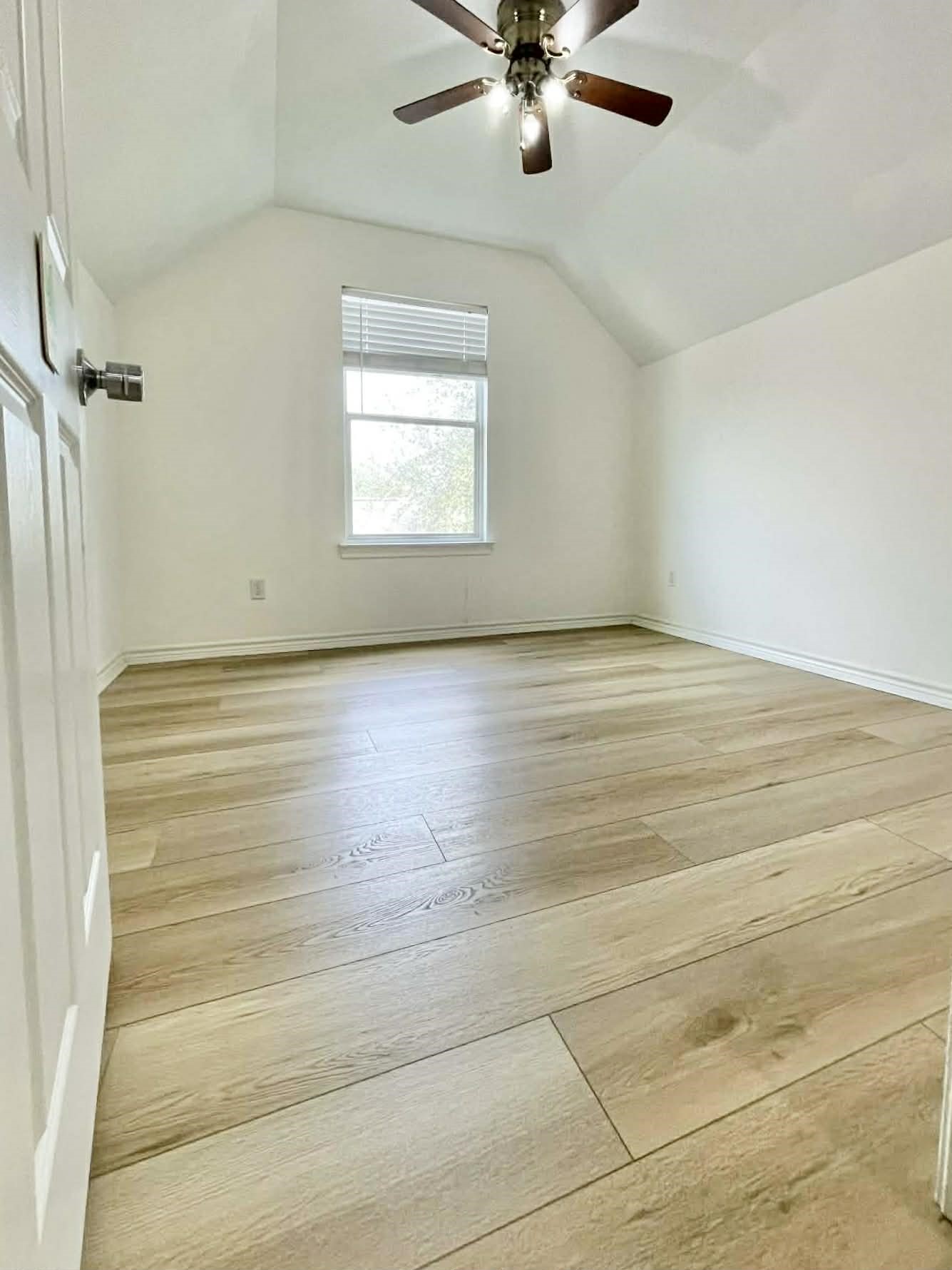 7916 Comal Street Houston, TX 77051 - Photo 3 of 21 en empty room with wooden floor fan and windows
