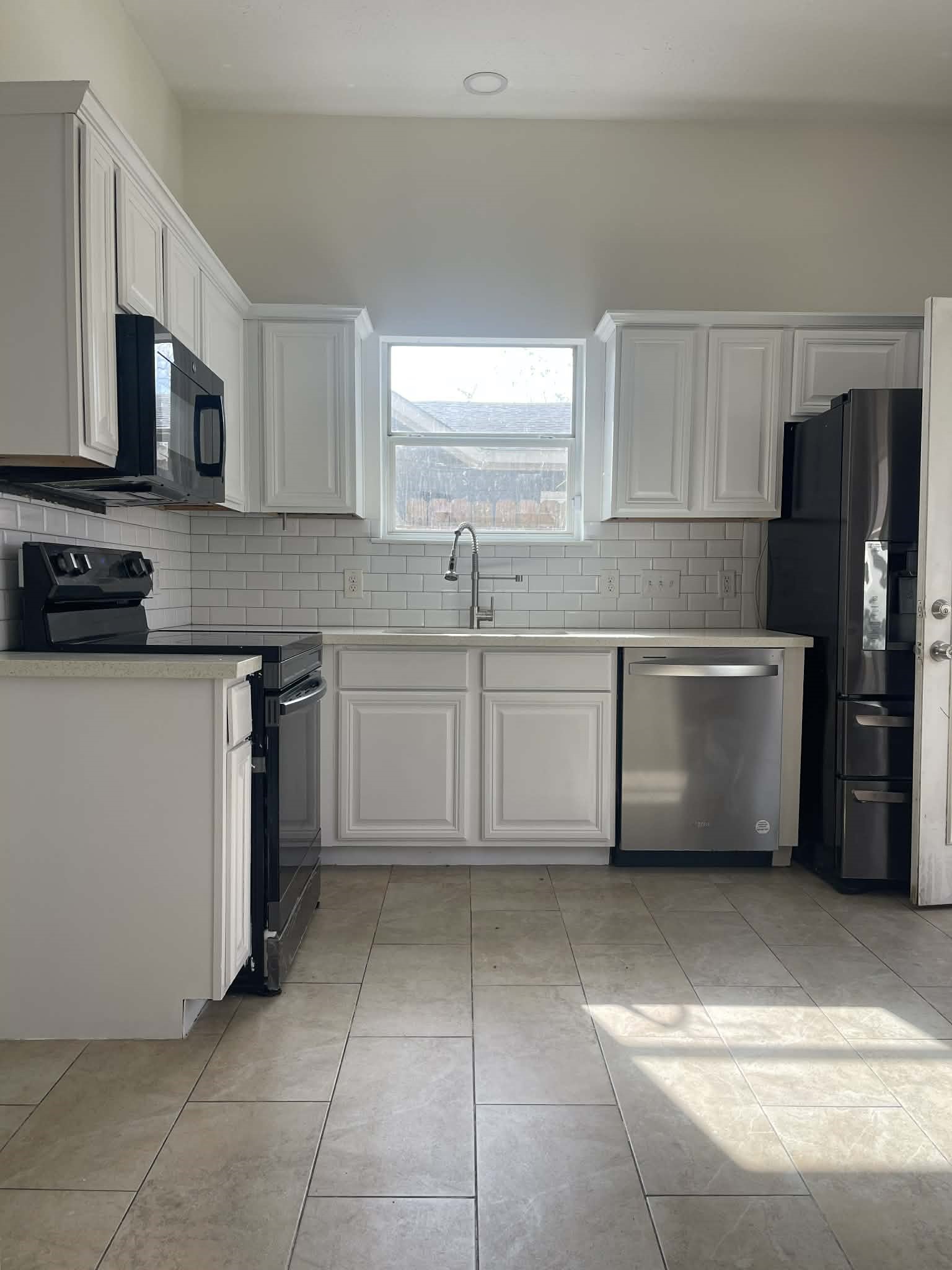 7916 Comal Street Houston, TX 77051 - Photo 6 of 21 a kitchen with stainless steel appliances a sink a stove a microwave a counter top space and cabinets