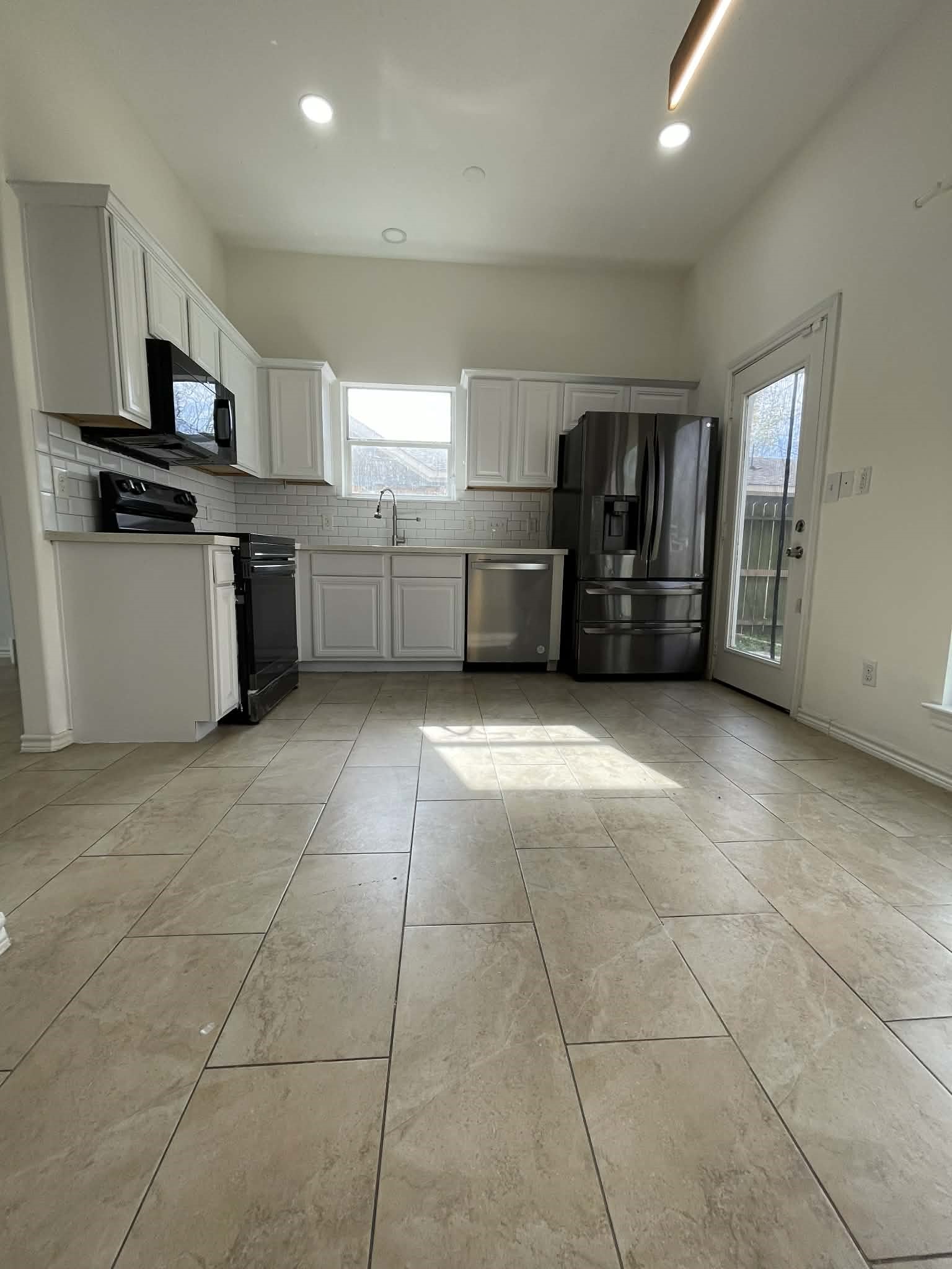 7916 Comal Street Houston, TX 77051 - Photo 9 of 21 a kitchen with granite countertop a sink a counter top space appliances and cabinets