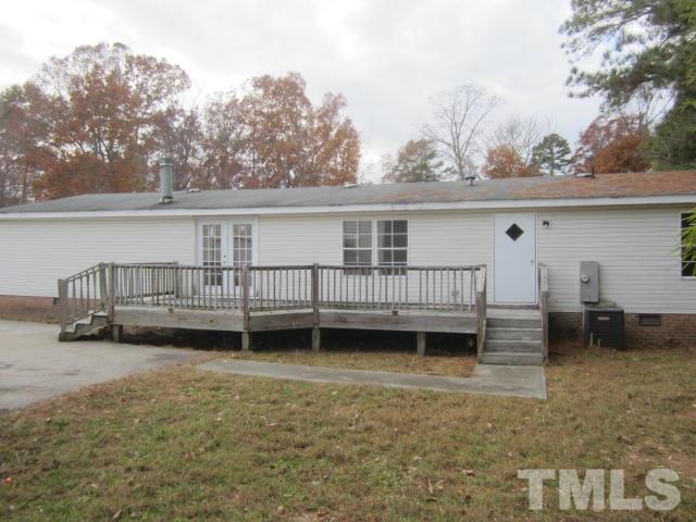 2329 Thee Hester Road Roxboro, NC 27574 - Photo 2 of 7 a backyard of a house with barbeque oven and outdoor seating