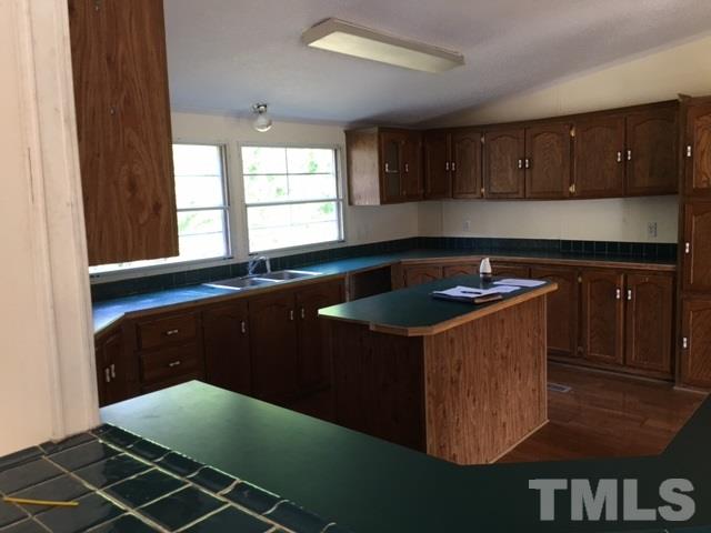 2329 Thee Hester Road Roxboro, NC 27574 - Photo 5 of 7 a kitchen with a sink cabinets and window