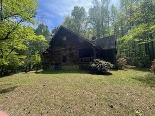 1301 Bob Hunton Road Douglasville, GA 30134 - Photo 2 of 14 a view of a backyard with potted plants and large trees