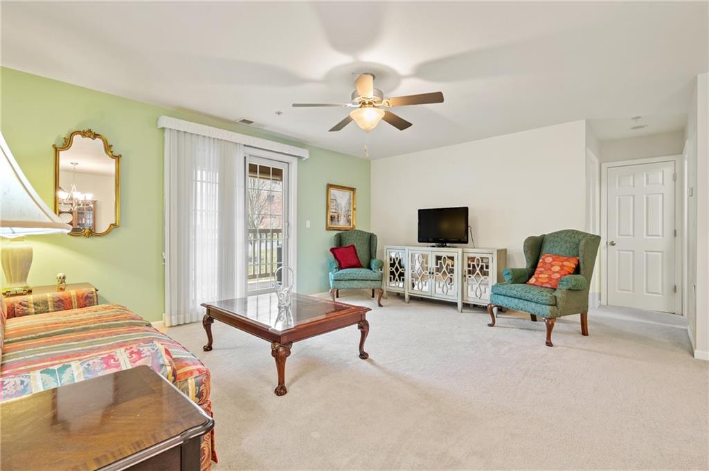 1 Coraopolis Road, Unit 303 Coraopolis, PA 15108 - Photo 11 of 22 a living room with furniture and a flat screen tv