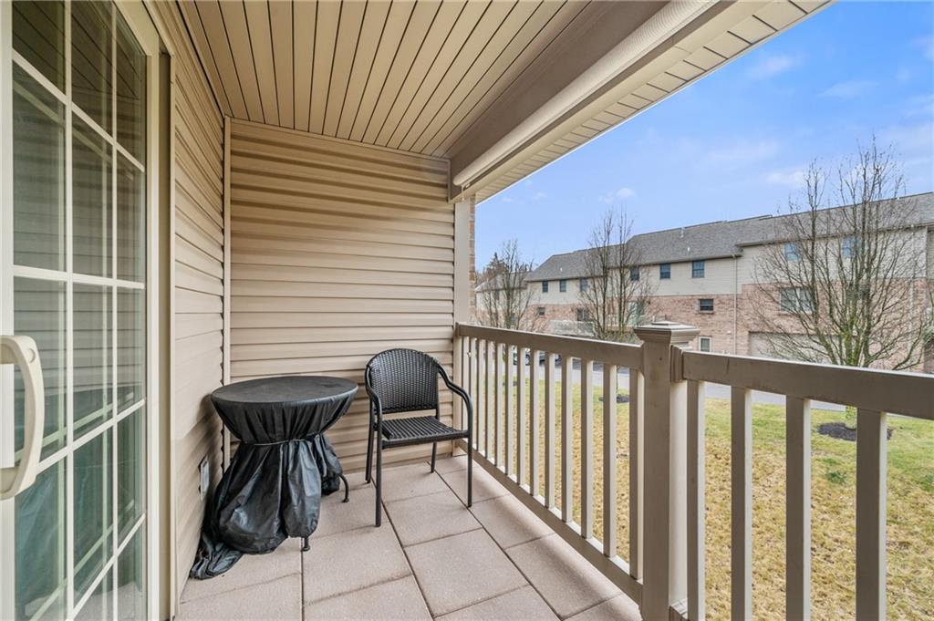 1 Coraopolis Road, Unit 303 Coraopolis, PA 15108 - Photo 17 of 22 a view of balcony with two chairs and a barbeque