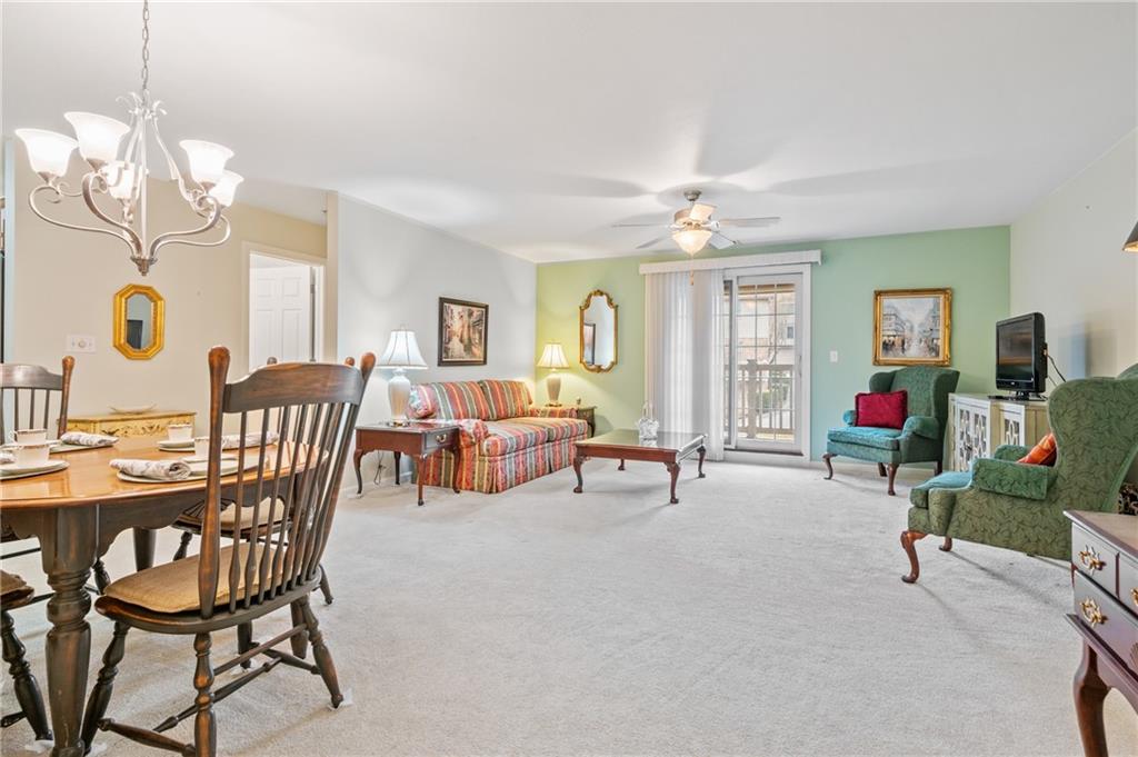 1 Coraopolis Road, Unit 303 Coraopolis, PA 15108 - Photo 5 of 22 a living room with furniture a chandelier and a window