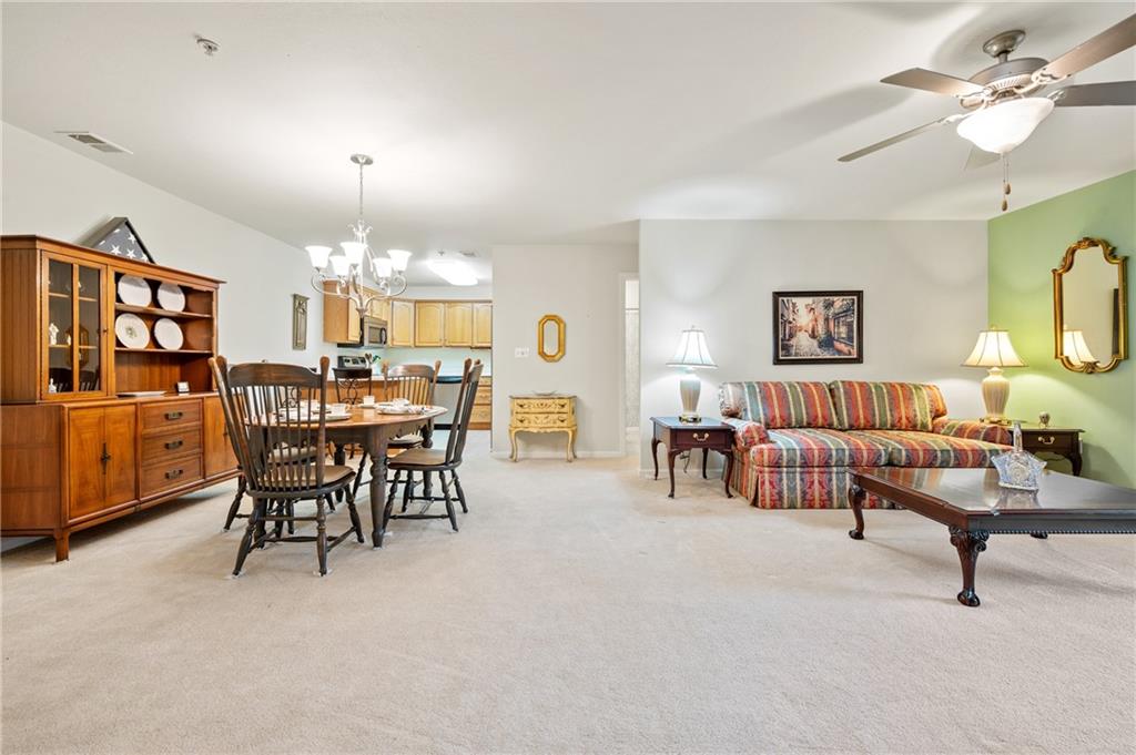 1 Coraopolis Road, Unit 303 Coraopolis, PA 15108 - Photo 6 of 22 a view of a dining room with furniture and chandelier
