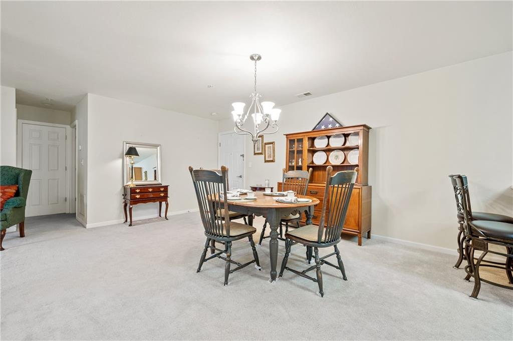 1 Coraopolis Road, Unit 303 Coraopolis, PA 15108 - Photo 7 of 22 a view of a dining room with furniture and chandelier