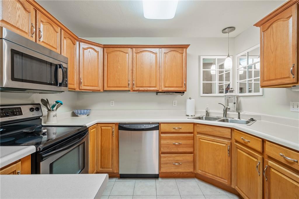 1 Coraopolis Road, Unit 303 Coraopolis, PA 15108 - Photo 9 of 22 a kitchen with stainless steel appliances granite countertop a sink stove and cabinets