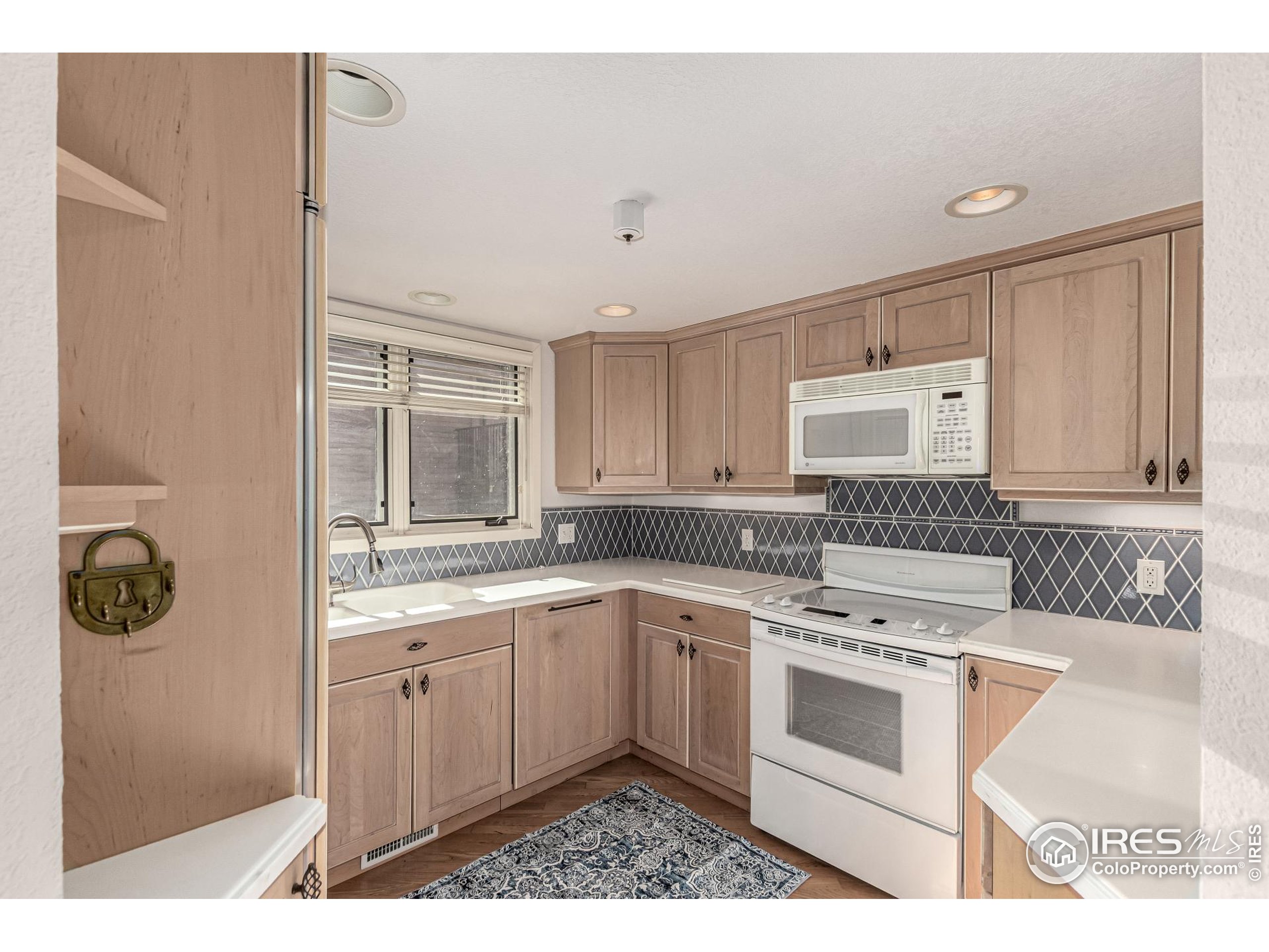 4415 Laguna Place, Unit 201 Boulder, CO 80303 - Photo 15 of 38 a kitchen with a stove a sink and cabinets