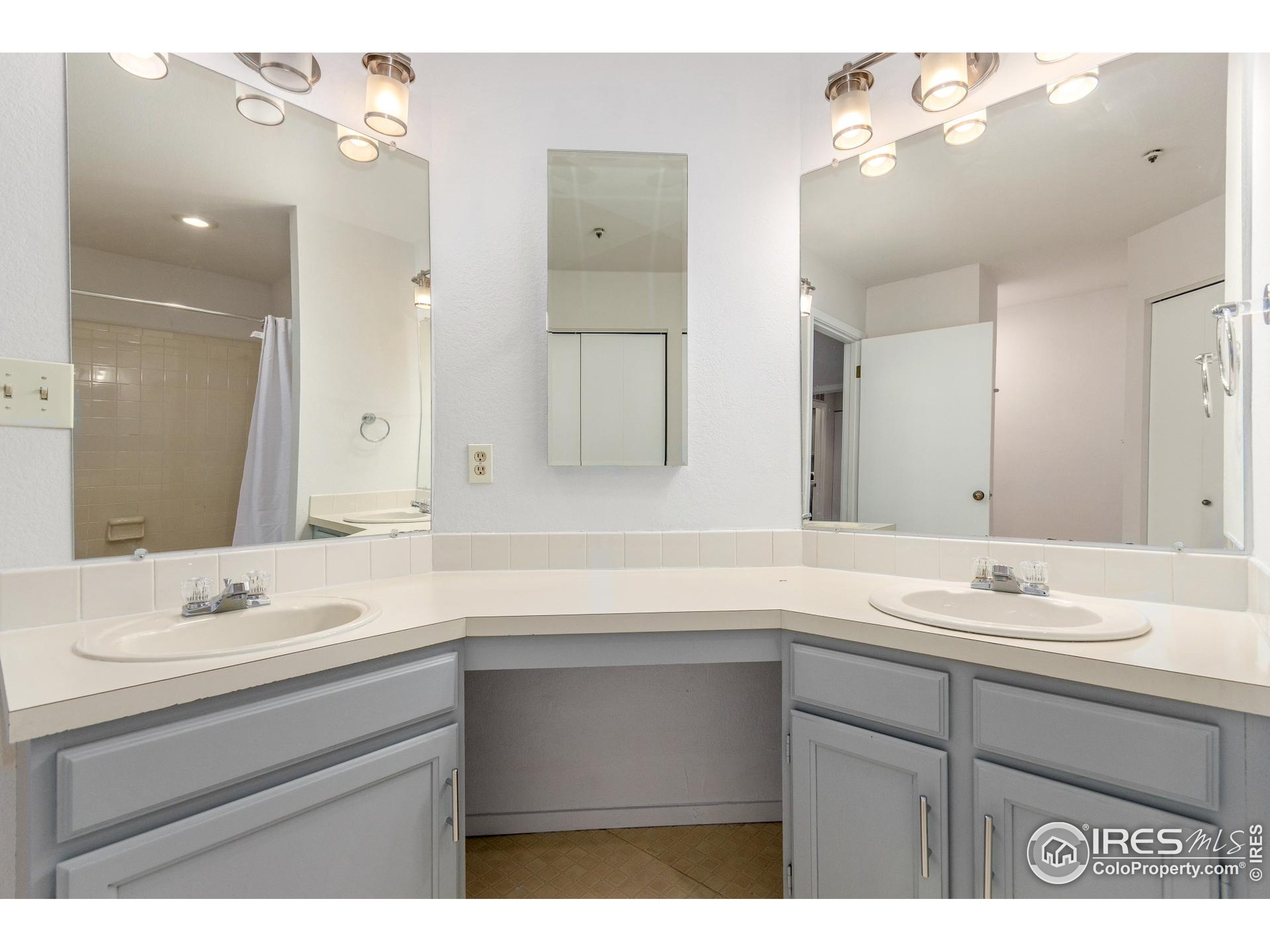 4415 Laguna Place, Unit 201 Boulder, CO 80303 - Photo 27 of 38 a bathroom with a sink vanity and a mirror