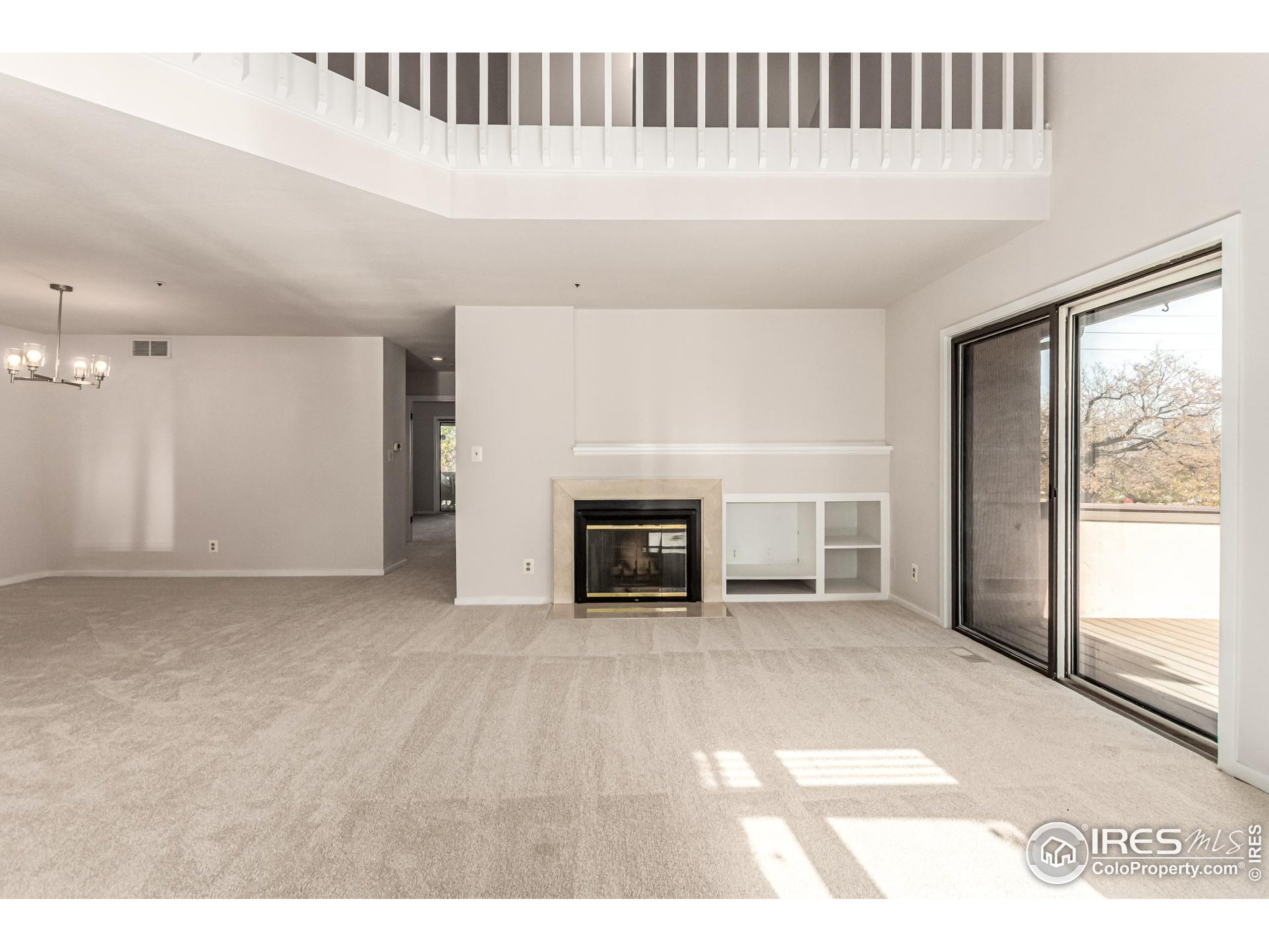4415 Laguna Place, Unit 201 Boulder, CO 80303 - Photo 9 of 38 a view of an empty room with a fireplace and a window