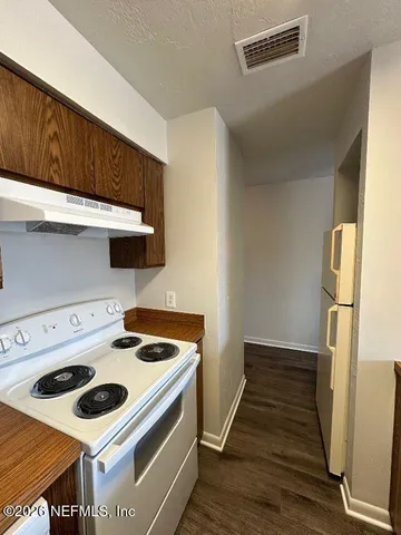 a kitchen with a stove and a refrigerator