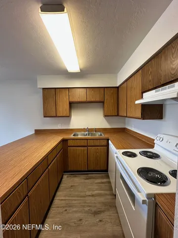 a kitchen with a stove and a sink