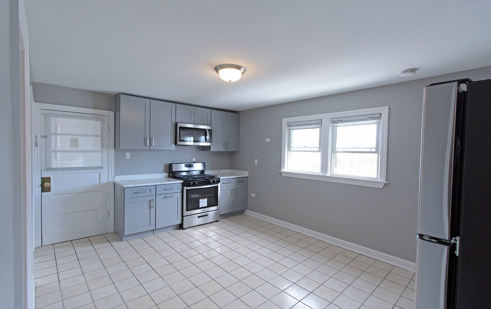 7535 West 58th Place Summit, IL 60501 - Photo 12 of 34 a kitchen with cabinets and window