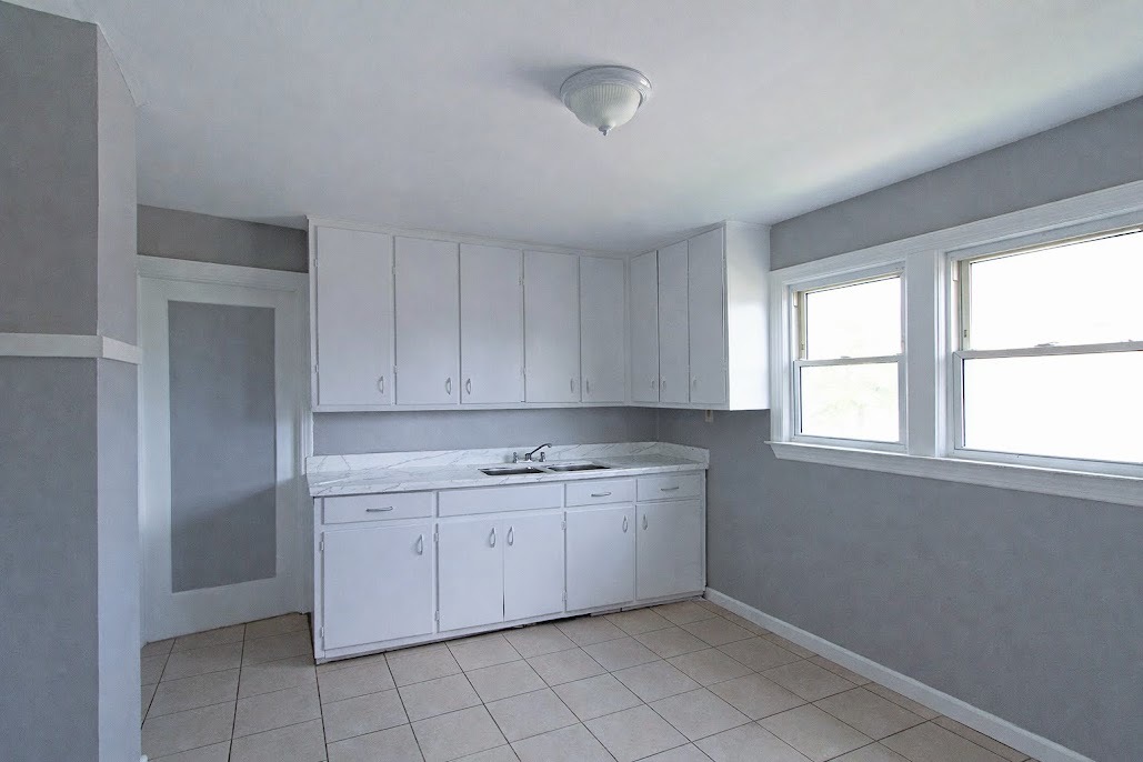 7535 West 58th Place Summit, IL 60501 - Photo 17 of 34 a view of cabinets a sink and a window in a room
