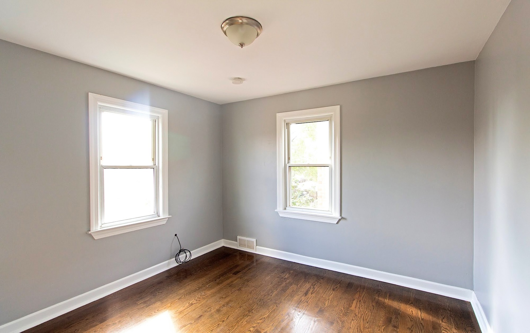 7535 West 58th Place Summit, IL 60501 - Photo 21 of 34 a view of an empty room with wooden floor and a window