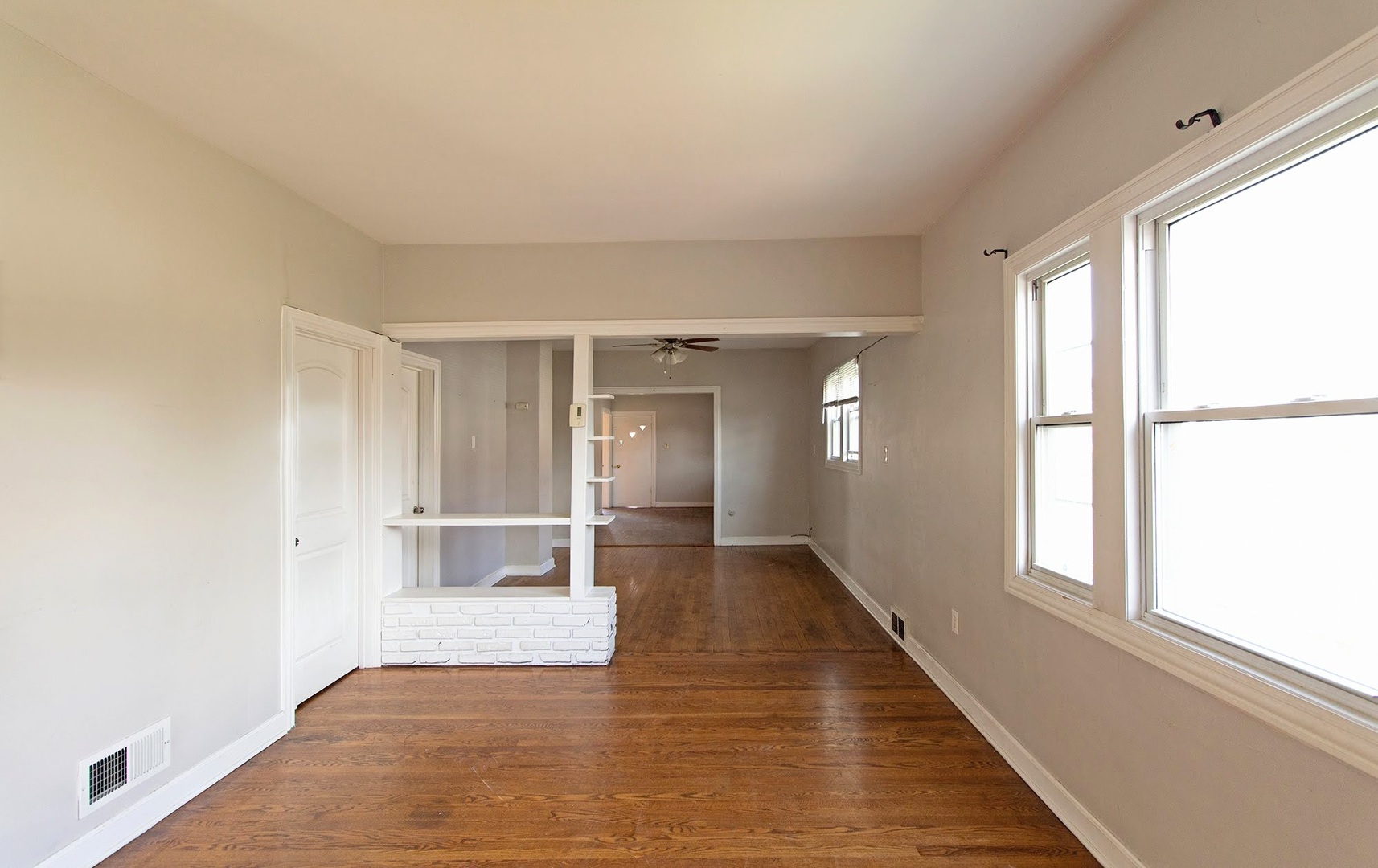 7535 West 58th Place Summit, IL 60501 - Photo 4 of 34 a view of an empty room with wooden floor and a window