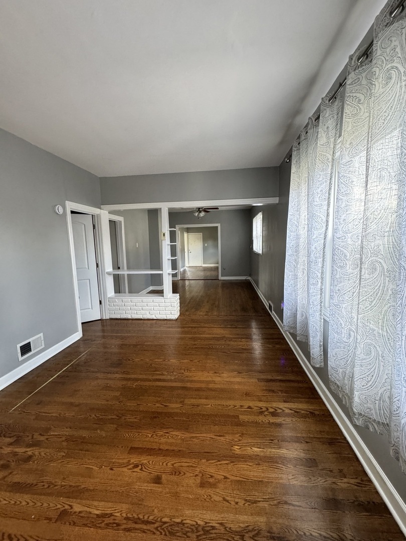 7535 West 58th Place Summit, IL 60501 - Photo 5 of 34 a view of an empty room with wooden floor and a window