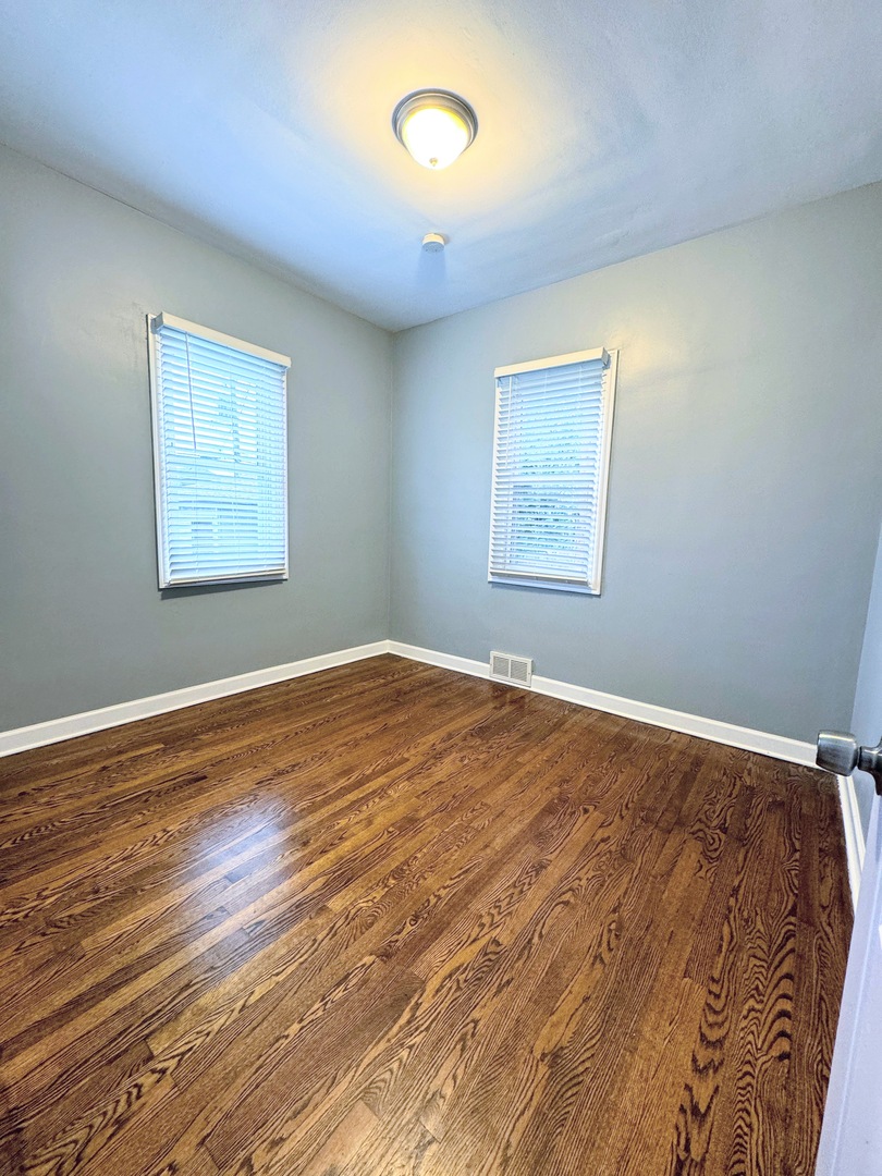 7535 West 58th Place Summit, IL 60501 - Photo 6 of 34 a view of a room with wooden floor and fan