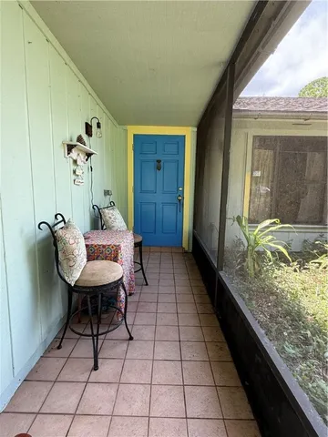 a balcony with chairs and wooden floor