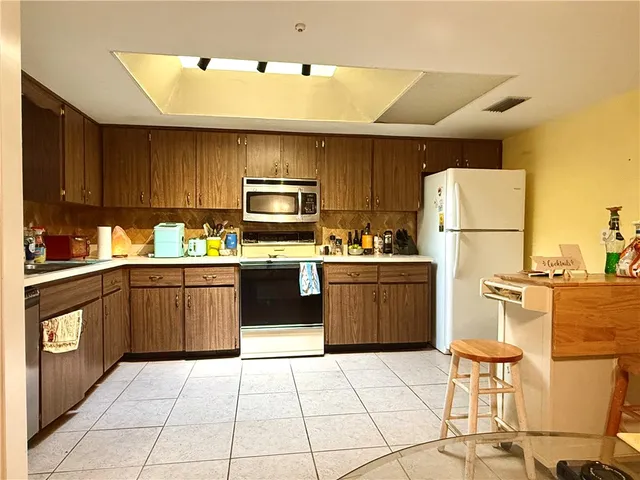 a kitchen with a sink a counter top space and appliances