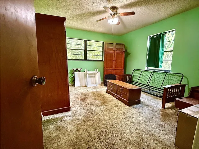 a spacious bedroom with a bed and window