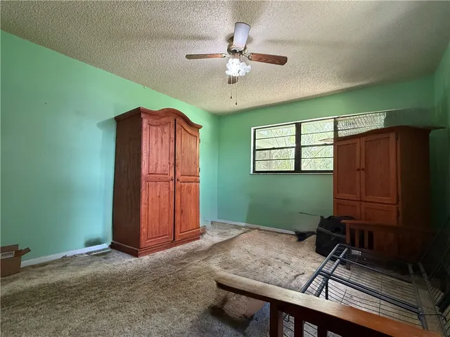 a room with furniture and a ceiling fan