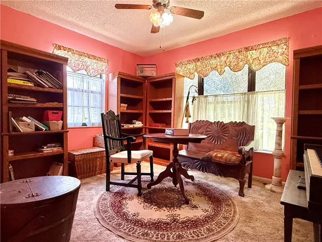 a living room with furniture and a floor to ceiling window