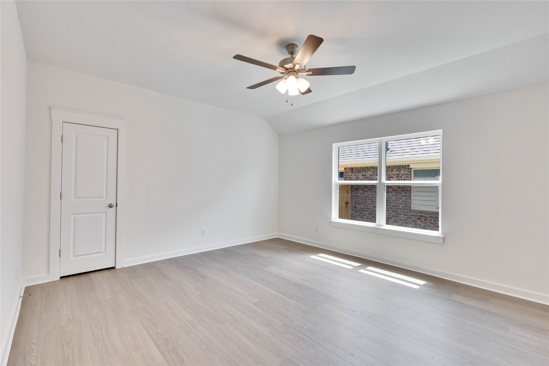 13509 Barn Chime Street Elgin, TX 78621 - Photo 17 of 30 Spare room with light wood-type flooring, vaulted ceiling, and ceiling fan