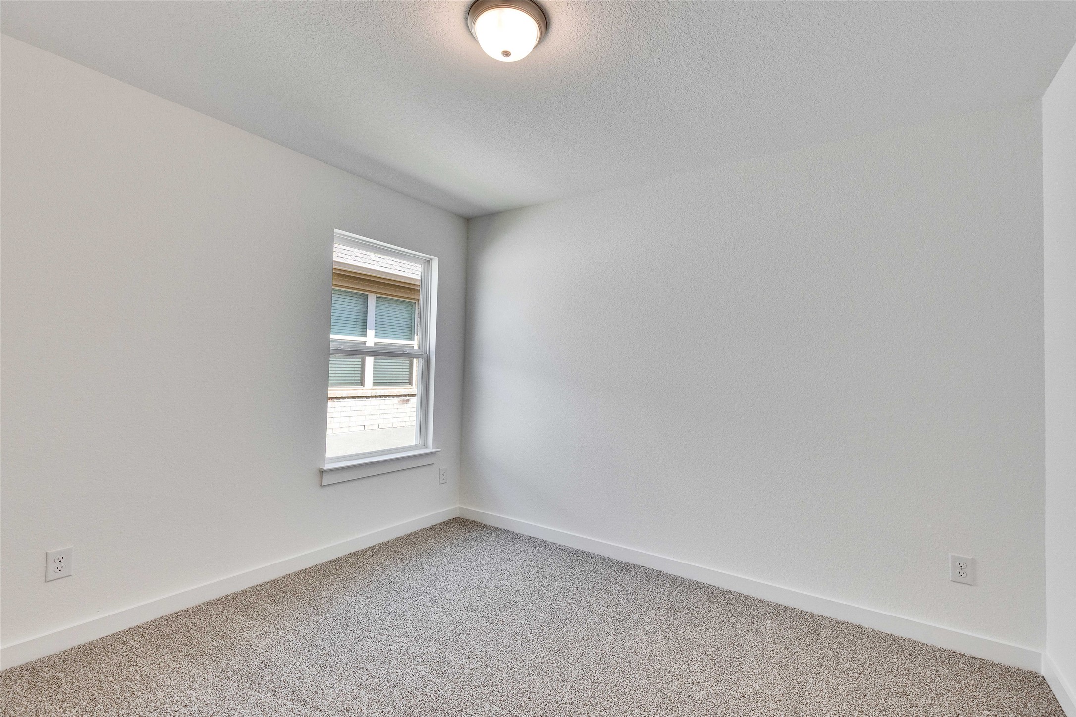 13509 Barn Chime Street Elgin, TX 78621 - Photo 27 of 30 Spare room featuring carpet floors and a textured ceiling