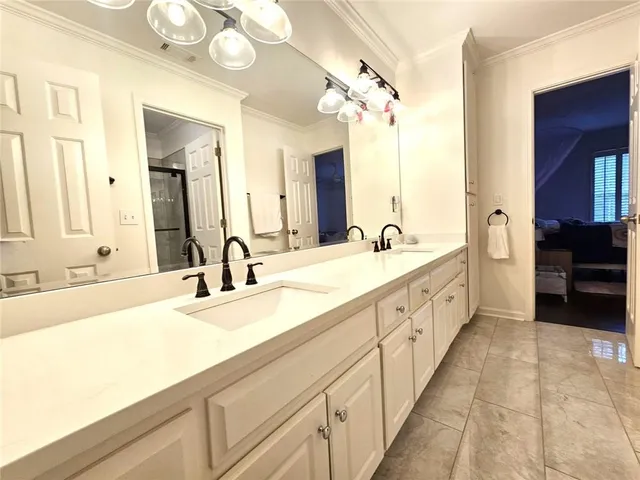 a spacious bathroom with a double vanity sink and a mirror
