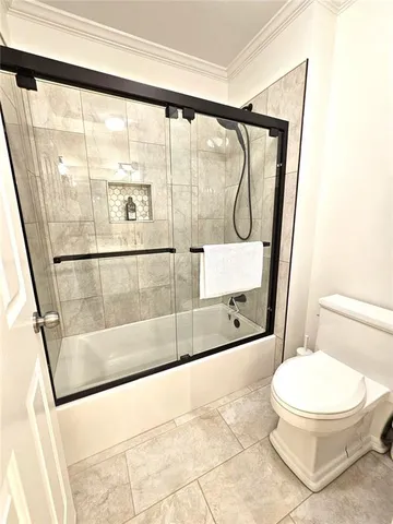 a bathroom with a toilet shower and a sink