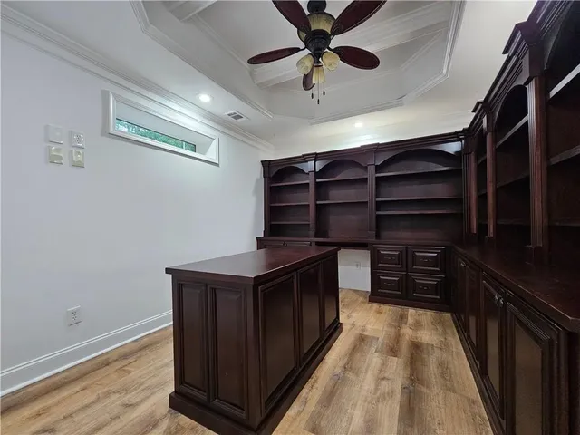 a kitchen with a cabinets and wooden floor