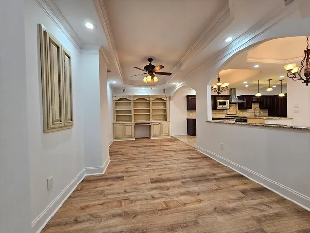 wooden floor in an empty room with a kitchen