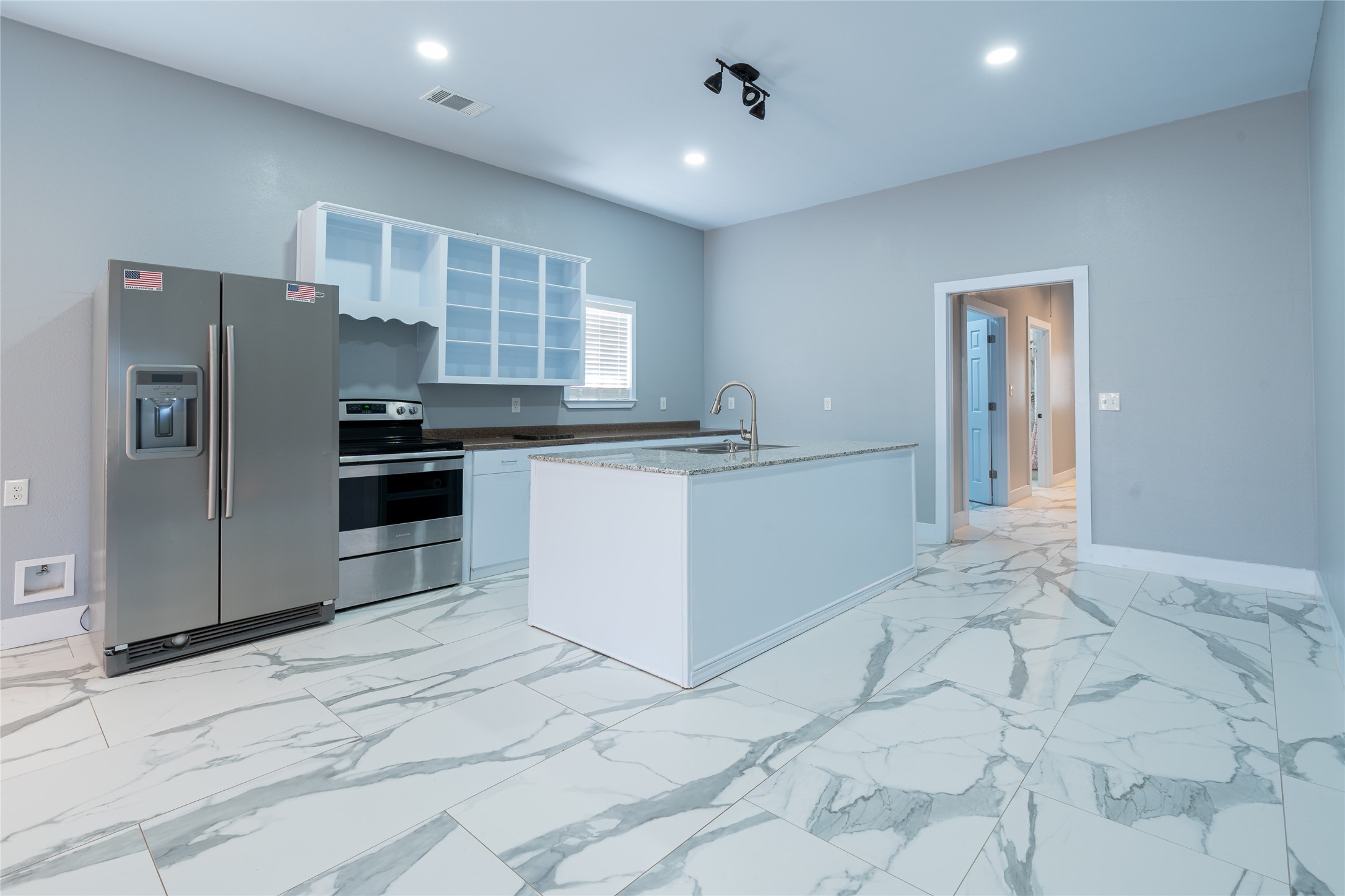 661 Hidden Oak Road Dale, TX 78616 - Photo 9 of 36 a kitchen with stainless steel appliances granite countertop a sink stove and refrigerator