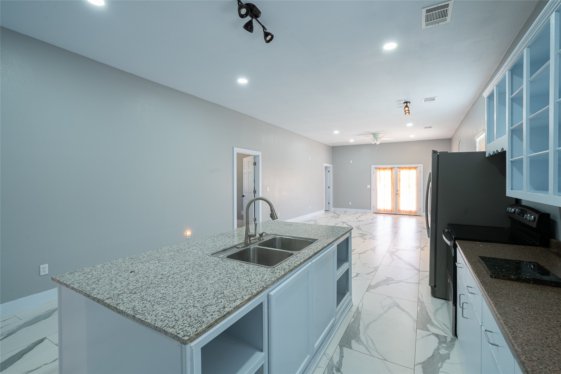 661 Hidden Oak Road Dale, TX 78616 - Photo 10 of 36 a kitchen with stainless steel appliances granite countertop a sink a refrigerator and a counter top