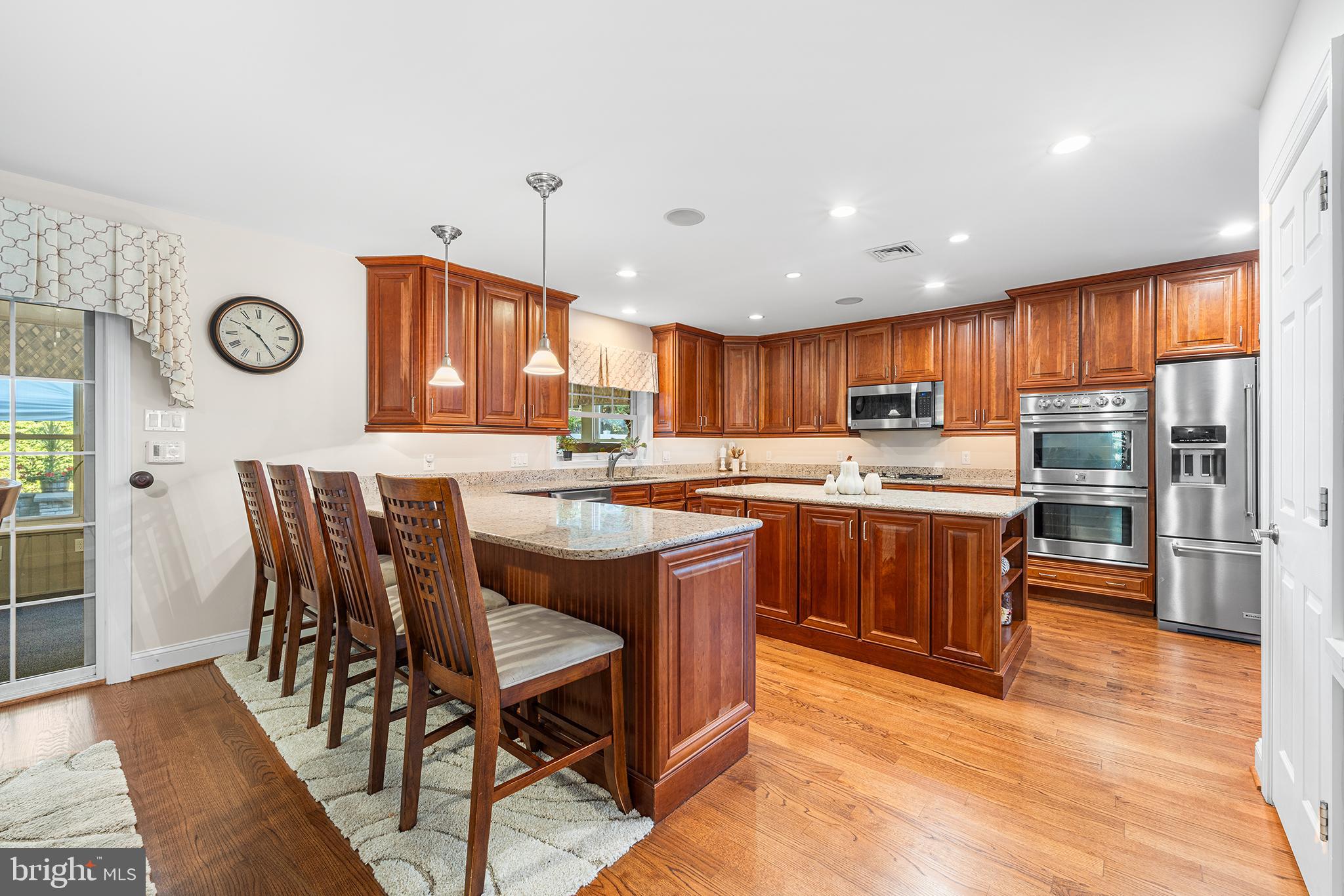 524 Sagamore Road Havertown, PA 19083 - Photo 14 of 43 a kitchen with stainless steel appliances granite countertop a table chairs sink and cabinets