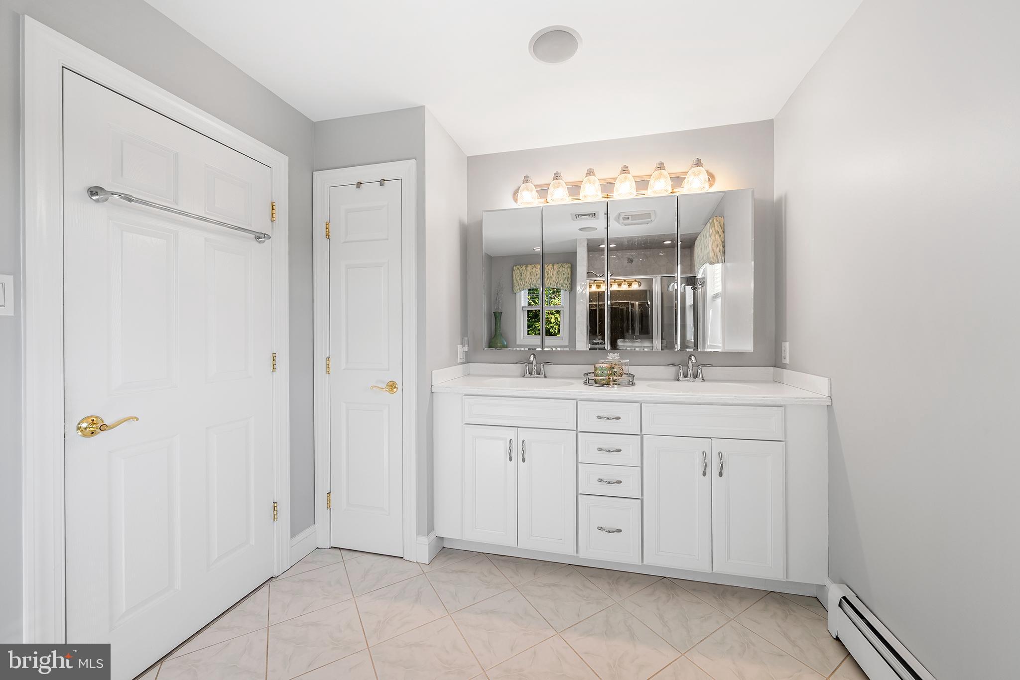 524 Sagamore Road Havertown, PA 19083 - Photo 32 of 43 a bathroom with a double vanity sink and a mirror